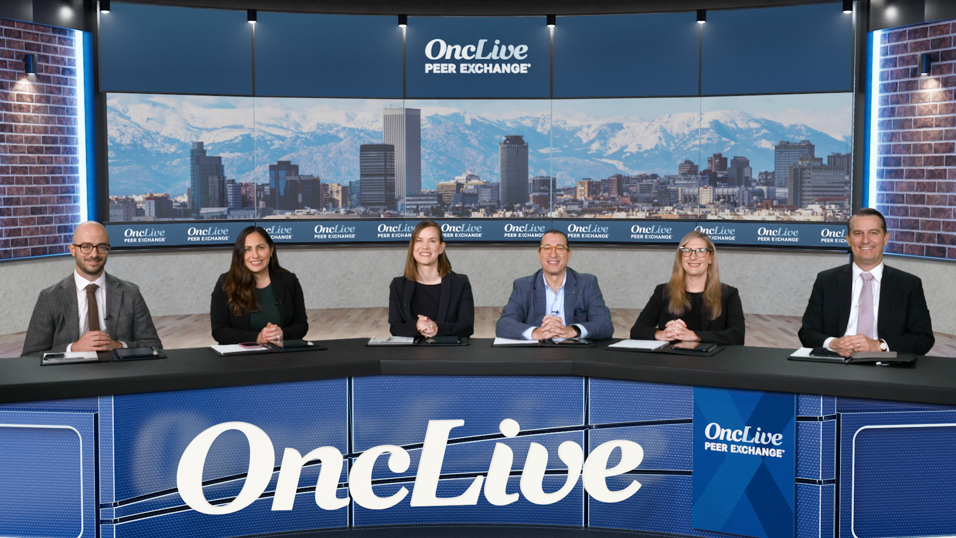 A panel of 6 experts on chronic lymphocytic leukemia seated at a long table